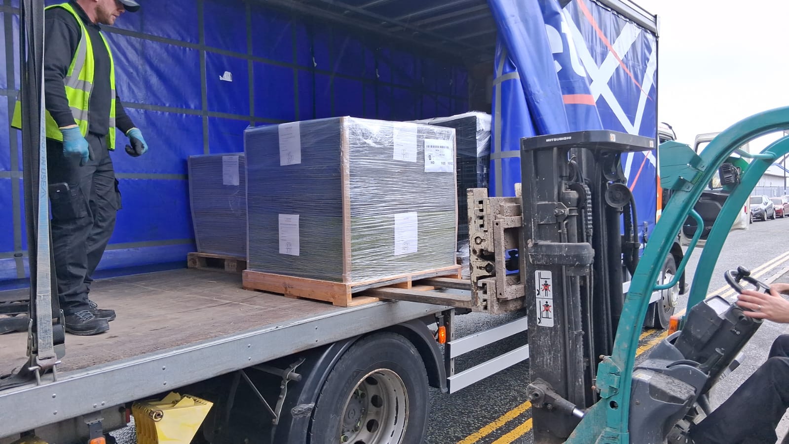Palletised renewed carpet tiles being unloaded for the Overbury site office project at LEGO London